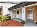 Charming covered front porch, and attractive plants leading to the front door at 7633 Piping Rock Ct # 7633, New Port Richey, FL 34654