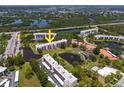 Aerial view of condominium complex featuring lakes, mangroves, and serene views of nature at 8174 Terrace Garden N Dr # 204, St Petersburg, FL 33709
