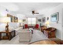 Cozy living room with carpet, ceiling fan, and lots of furniture, decor, and natural light at 8174 Terrace Garden N Dr # 204, St Petersburg, FL 33709