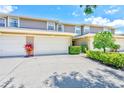 Charming townhome exterior featuring well-maintained garages and vibrant landscaping at 8253 118Th Ave, Largo, FL 33773