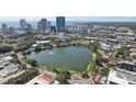 Scenic aerial view of downtown featuring a tranquil lake surrounded by lush green trees and modern buildings at 841 4Th N Ave # 55, St Petersburg, FL 33701