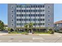 Suncoast Towers building featuring a gray exterior, ample windows, and a well-manicured lawn at 841 4Th N Ave # 55, St Petersburg, FL 33701