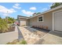 A single-story home with a paved walkway leading to the front door and attached garage at 8433 101St Ave, Seminole, FL 33777