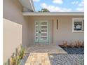 Stylish front door with glass inserts, complementing the home's modern exterior at 8433 101St Ave, Seminole, FL 33777