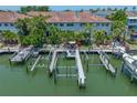 Aerial view showcases boat docks and outdoor living, providing waterfront relaxation and entertainment at 903 Pinellas Bayway S # 103, Tierra Verde, FL 33715