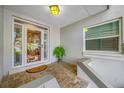 Inviting front porch featuring tile flooring and decorative glass windows at 903 Pinellas Bayway S # 103, Tierra Verde, FL 33715