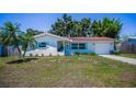 Beautiful single-story home featuring a red tile roof, an attached garage and a well-manicured front yard at 9952 111Th St, Seminole, FL 33772