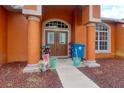 Close up of the double door front entrance with red mulch and covered porch at 3234 Morven Dr, Spring Hill, FL 34609