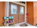 Close up of the double door front entrance with pots and outdoor decor at 3234 Morven Dr, Spring Hill, FL 34609