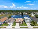 Aerial view of a beautiful home in a waterfront neighborhood with lush landscaping at 10205 Charleston Corner Rd, Tampa, FL 33635