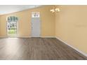 Bright living room with new laminate flooring, large windows, and natural light at 10205 Charleston Corner Rd, Tampa, FL 33635