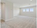 Spacious bonus room featuring plush carpeting, recessed lighting, and plentiful natural light from three windows at 10320 Longmeadow Ave, Parrish, FL 34219