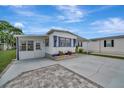 Inviting home with a covered parking, well-kept landscaping, and a concrete driveway at 104 E Saint Johns Way, Apollo Beach, FL 33572