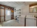 Functional laundry room with washer, dryer, and shelving, ready for your appliances at 104 E Saint Johns Way, Apollo Beach, FL 33572