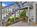 Staircase leading to an upper-level unit with colorful potted plants creating a welcoming entrance at 11201 122Nd Ave # 167, Largo, FL 33778