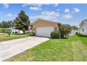 Well-maintained single-story home with a paved driveway and lush green lawn at 11746 93Rd Ave, Seminole, FL 33772