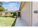 Inviting front entrance with a manicured lawn and a charming arched doorway at 11746 93Rd Ave, Seminole, FL 33772
