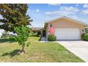 Charming single-story home with a manicured lawn and an attached two-car garage at 11746 93Rd Ave, Seminole, FL 33772
