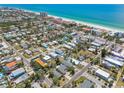 Breathtaking aerial view of homes nestled near a stunning coastline with crystal-clear turquoise waters at 123 14Th Ave, Indian Rocks Beach, FL 33785