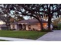 Inviting single-story home with a well-kept lawn and elegant architectural details at 13133 Roseanna Dr, Spring Hill, FL 34609