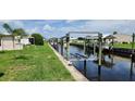 Scenic view of a waterfront property with boat lifts and lush green landscaping at 134 W Saint Annes Cir, Apollo Beach, FL 33572