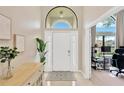 Bright foyer with white door, decorative rug and large window above at 1806 Powder Ridge Dr, Valrico, FL 33594