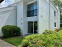 Condo exterior with sliding glass doors leading to a small patio and garden area at 2060 Marilyn St # 121, Clearwater, FL 33765