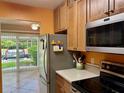 Kitchen featuring stainless steel appliances, cooktop stove, and lots of natural light at 2060 Marilyn St # 121, Clearwater, FL 33765