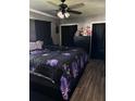 Comfortable bedroom featuring dark accents, a ceiling fan, and ample natural light at 2198 Academy Dr, Clearwater, FL 33764