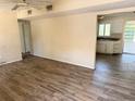 Open-concept living room featuring wood-look floors and seamless flow to kitchen at 2271 Terrace N Dr, Clearwater, FL 33765