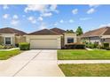 Beautiful single-Gathering home featuring a manicured lawn, two-car garage, and inviting curb appeal at 26338 Whirlaway Ter, Wesley Chapel, FL 33544