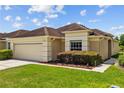 Lovely single-story house with a well-kept lawn, attached two-car garage, and tasteful landscaping at 26338 Whirlaway Ter, Wesley Chapel, FL 33544