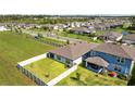 Residential neighborhood aerial view showcasing backyard fencing and nearby landscaping at 3935 Capri Coast Dr, Plant City, FL 33565