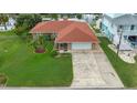 Charming single-story home with well-manicured lawn, a spacious driveway, and an attached one car garage at 4299 Bellaire Dr, Hernando Beach, FL 34607
