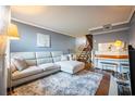 A cozy living room featuring a comfortable L-shaped couch, plush rug, and inviting decor at 4314 La Mora Ct, Tampa, FL 33611