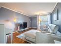 Inviting living room with a modern couch, large television, and hardwood floors at 4314 La Mora Ct, Tampa, FL 33611