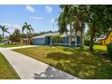 Well-maintained single-story home with lush lawn, mature trees and an attached garage at 4612 35Th E Ave, Palmetto, FL 34221