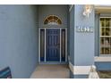 Close up of the blue front door with sidelights, arched transom and house numbers at 4612 35Th E Ave, Palmetto, FL 34221