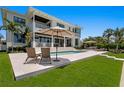 Expansive backyard featuring a pool, lounge area, and manicured lawn perfect for outdoor relaxation and entertaining at 5110 W Longfellow Ave, Tampa, FL 33629