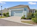 Detached garage shows great curb appeal with blue paint, updated lights, and tidy landscaping at 610 Winterside Dr, Apollo Beach, FL 33572