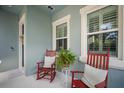 Inviting porch featuring rocking chairs, a fern, and serene ambiance for relaxation and enjoyment at 610 Winterside Dr, Apollo Beach, FL 33572
