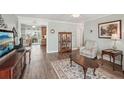 Comfortable living room featuring wood-look floors and an open floor plan at 708 Rutgers Pl, Sun City Center, FL 33573