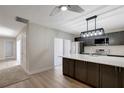 This modern kitchen offers a large island, stainless steel appliances, and a view of the stairs and backyard at 739 1St Ct, Palm Harbor, FL 34684