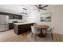 Bright eat-in kitchen features modern stainless steel appliances, white countertops, and stylish pendant lighting at 739 1St Ct, Palm Harbor, FL 34684