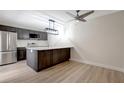 Spacious kitchen with a large island, stainless steel appliances, and contemporary pendant lighting at 739 1St Ct, Palm Harbor, FL 34684
