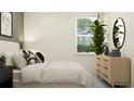 Inviting bedroom with natural light, wooden dresser, mirror, and indoor potted plant at 7541 E 116Th St, Palmetto, FL 34221