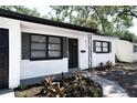 Close-up of front exterior featuring modern color scheme, manicured landscaping, and welcoming front door at 8059 26Th N Ave, St Petersburg, FL 33710