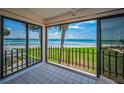 Enjoy the outdoors from this enclosed patio with bay views, tile flooring, and sliding glass doors at 865 S Gulfview Blvd # 202, Clearwater Beach, FL 33767