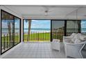 Relaxing enclosed patio with stunning ocean views, tile flooring and comfortable seating area to enjoy the outdoors at 865 S Gulfview Blvd # 202, Clearwater Beach, FL 33767