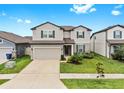 Charming two-story home with a well-maintained lawn and two-car garage at 9293 Rally Spring Loop, Wesley Chapel, FL 33545